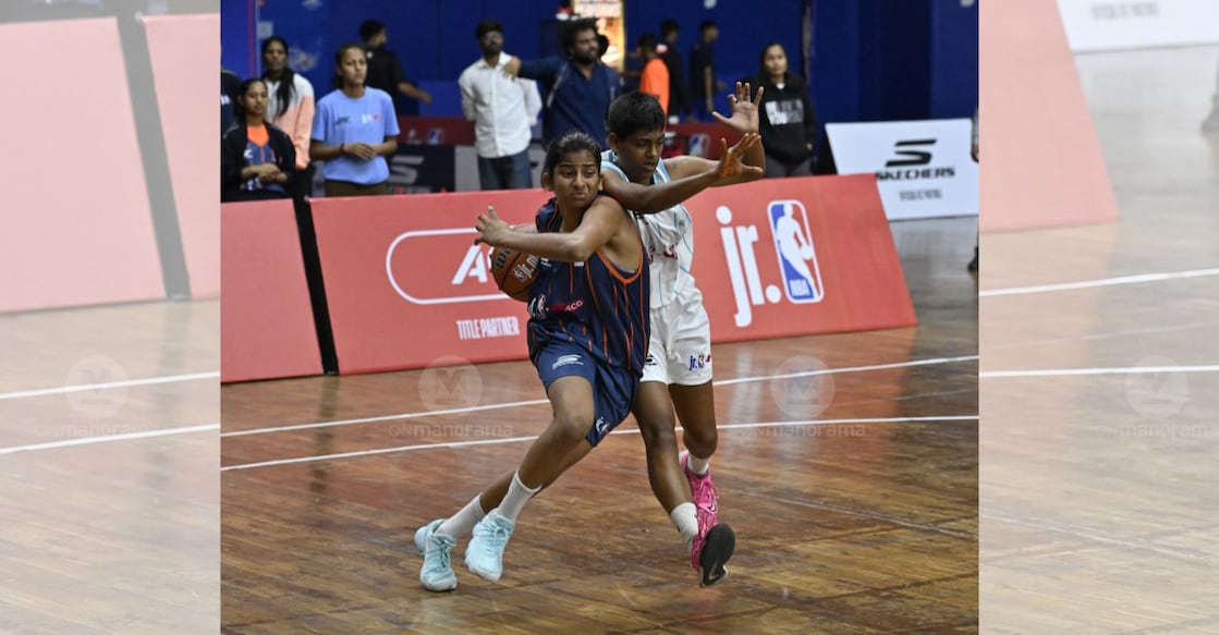 A player of Providence HSS, Kozhikode (blue) competes with an opponent from Maa Sharda Public School, Prayagraj, in the semifinal of the ACG Junior NBA 3X3 National at the KD Jadhav Indoor Stadium in New Delhi on March 23, 2026. Photo: Josekutty Panackal/Malayala Manorama