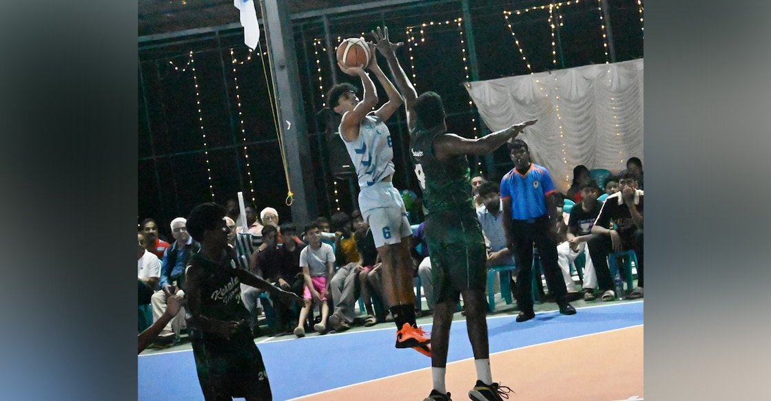 Rithin Murali (White jersey) of St Alberts College scoring against Sree Kerala Varma College during the men's final of the St Thomas Basketball Tournament in Niranam. Photo: Special arrangement