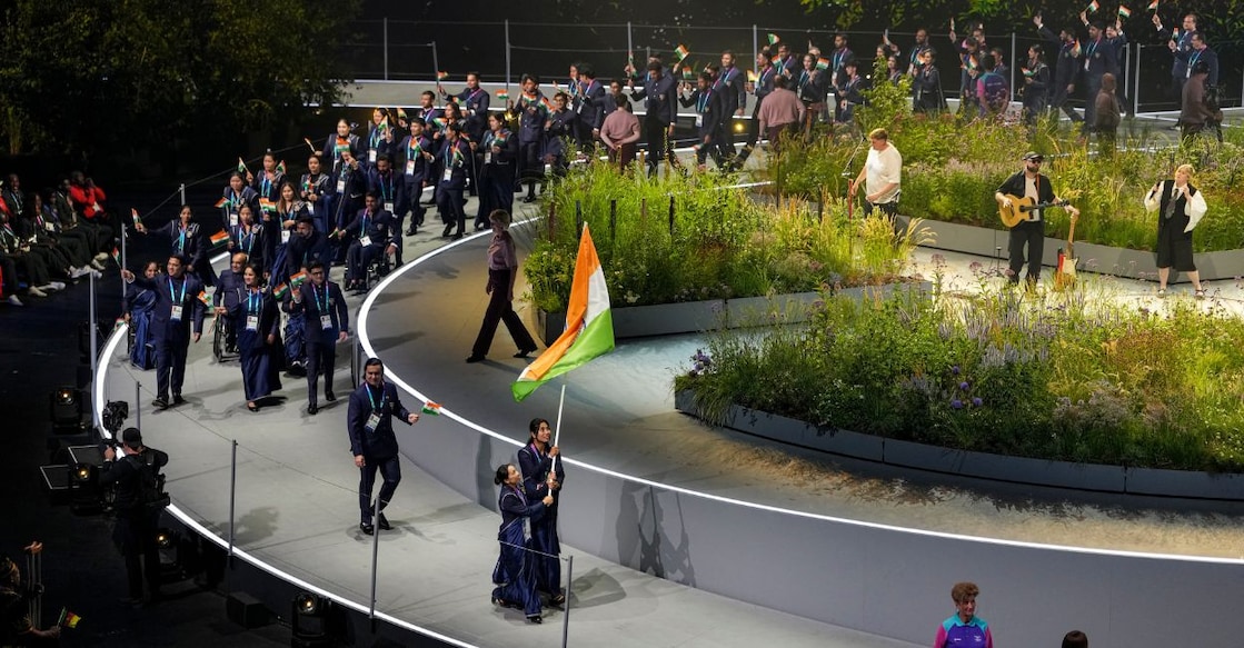 India's weightlifter Mirabai Chanu and boxer Lovlina Borgohain lead the Indian contingent carrying the national tricolour during the Parade of Nations at the opening ceremony of the 23rd Commonwealth Games. Photo: PTI