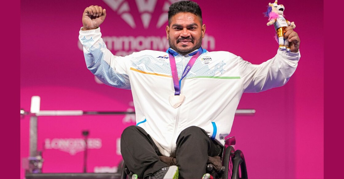 India's Jhandu Kumar posing for a photograph after winning a bronze medal in para powerlifting at the Commonwealth Games 2023. Photo: PTI
