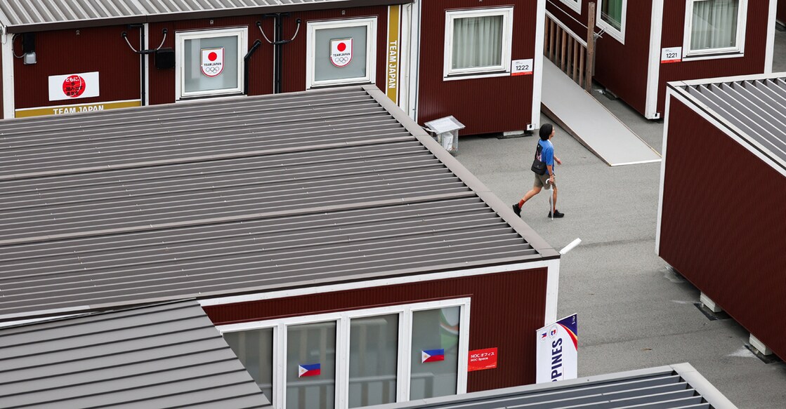 A person walks near wooden container units built to house athletes, including those for Japanese and Filipino athletes, ahead of the Aichi-Nagoya 2026 Asian Games in Nagoya, Japan, September 15, 2026. REUTERS/Edgar Su
