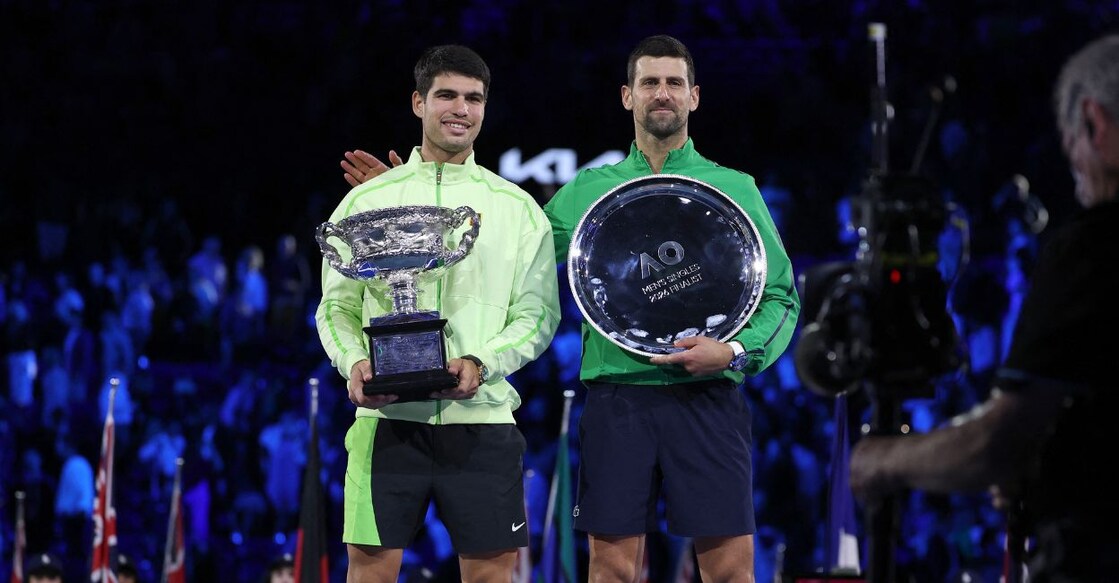 Spain's Carlos Alcaraz (L) and runner-up Serbia's Novak Djokovic pose for photos on the podium after the men's singles final of the Australian Open tennis tournament. Photo: AFP