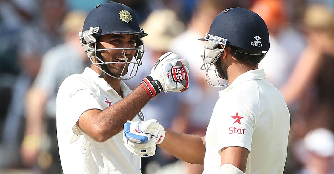India's Bhuvneshwar Kumar (left) celebrates with his teammate Mohammed Shami after scoring a half century during day two of the first Test against England at Trent Bridge in Nottingham, central England on July 10, 2014. File photo: AFP/ Andrew Yates