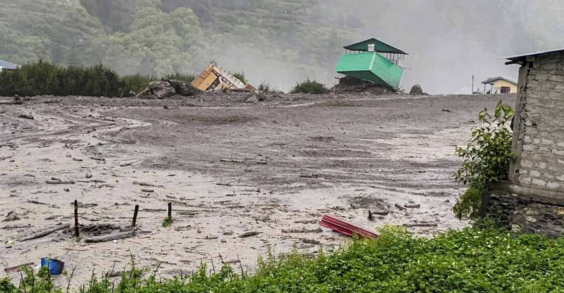 Houses and other structures are being swept away in flash floods triggered by a cloudburst at Kheer Gad area in Dharali of Uttarkashi district, Uttarakhand. Photo: PTI