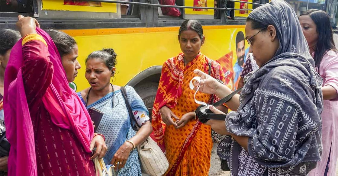 A conductor issues tickets to women passengers after the statewide free bus travel scheme for women comes into effect. Photo: PTI