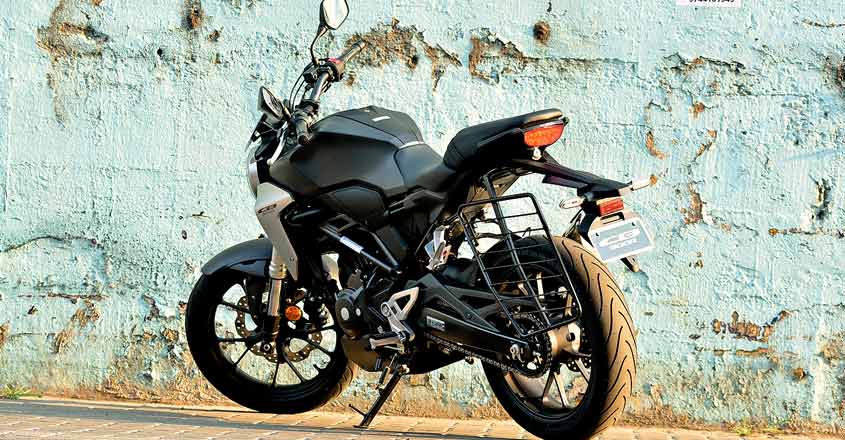 CB300R is Honda's international offering in the entry-level naked sports category. A sports bike much-awaited by enthusiasts in India. Why? There is only one answer, quality. You could blindly trust the build quality, says an admirer. Moreover, enthusiasts are expecting the same quality levels seen in international model here too. Is it true? Is it only about quality? What about performance? Well, here is our test ride report: Global star The CB300R was first launched in 2017. It then came as a replacement for the CB300F model, which was a naked bike with sporty looks. However, CB300R is a mix of sportiness and retro style. Superb finish When we first saw CB300R at EVM Honda Wing World Cochin, we understood why there is so much talk about the quality aspect - the build quality is pretty impressive. The paint quality and finishing too are top class. Honda is calling it the Neo-Sports Cafe. It sports the chiselled looks of a street sports bike. The body panels are sleek. The round headlamp ooze quality and design excellence. The blacked-out engine and alloys stand out. The fuel tank is long and muscular. Knee recesses are deep and can comfortably accommodate your knees. The silver scoop next to it adds to its looks. The CB300R shares its design elements with its bigger brother CB100R. Engine and other components are in black theme. There are some silver finishes at some places, which add to its premium feel. The LCD instrument console is fully digital that is clearly visible in bright daylight too. It shows gear shift indicators, average mileage and instant fuel efficiency etc. It features a flat handle bar that supports an aggressive riding position. The quality of switches is top notch. The position of horn switch could create some confusion initially. The bike is built around a diamond type trellis frame. It is designed in such a way that the rider’s weight is brought closer to the centre of the motorcycle. The CB300R weighs only 147 kg thus making it a pretty nimble handling bike. Compared to its rivals like KTM Duke 390, BMW 310R, it weighs considerably less. The wheelbase is also shorter than the rivals at 1344 mm. The split seat offers good cushioning. You sit 800 mm off the ground (Duke 390 - 830mm, G310 - 785 mm) which makes it easy for short riders. The tail section gets a sporty design. The dual chamber exhaust on the rear sports contrasting black with chrome underslung. Engine The CB300R is powered by a 286.01 cc liquid-cooled single-cylinder engine. It churns out 30.4 bhp of peak power and 27.4 Nm of peak torque. The engine comes mated to a six-speed manual transmission. The engine is very refined and delivers what is generally expected from a Honda. Throttle response is excellent. Though it has good low-end grunt, the mid-range is commendable. The power delivery is smooth. Ride comfort is another standout feature of the CB300R. Handling is sharp and you can filter through city traffic easily. Straight-line stability is good even at higher speeds. Even if you are riding for the first time, the CB300R offers you the same feel of a bike that you have been using for long. The bike gets fat 41 mm USD forks up front and a seven-step pre-load adjustable monoshock at the rear. It also gets a dual-channel ABS (anti-lock braking system) with an inertia measuring unit which distributes braking of the ABS. The motorcycle features disc brakes both up front and at the back with a radially-mounted, four-piston caliper taking care of braking duties up front and a single-piston caliper unit at the rear. The last word The CB300R boasts international build quality, classy looks and a sporty feel. The ride quality and performance too are superb. Vehicle provided by ECM Honda Wing World Cochin Ph. 9895661188 CB300R is Honda's international offering in the entry-level naked sports category. A sports bike much-awaited by enthusiasts in India. Why? There is only one answer, quality. You could blindly trust the build quality, says an admirer. Moreover, enthusiasts are expecting the same quality levels seen in international model here too. Is it true? Is it only about quality? What about performance? Well, here is our test ride report: Global star The CB300R was first launched in 2017. It then came as a replacement for the CB300F model, which was a naked bike with sporty looks. However, CB300R is a mix of sportiness and retro style. Superb finish When we first saw CB300R at EVM Honda Wing World Cochin, we understood why there is so much talk about the quality aspect - the build quality is pretty impressive. The paint quality and finishing too are top class. Honda is calling it the Neo-Sports Cafe. It sports the chiselled looks of a street sports bike. The body panels are sleek. The round headlamp ooze quality and design excellence. The blacked-out engine and alloys stand out. The fuel tank is long and muscular. Knee recesses are deep and can comfortably accommodate your knees. The silver scoop next to it adds to its looks. The CB300R shares its design elements with its bigger brother CB100R. Engine and other components are in black theme. There are some silver finishes at some places, which add to its premium feel. The LCD instrument console is fully digital that is clearly visible in bright daylight too. It shows gear shift indicators, average mileage and instant fuel efficiency etc. It features a flat handle bar that supports an aggressive riding position. The quality of switches is top notch. The position of horn switch could create some confusion initially. The bike is built around a diamond type trellis frame. It is designed in such a way that the rider’s weight is brought closer to the centre of the motorcycle. The CB300R weighs only 147 kg thus making it a pretty nimble handling bike. Compared to its rivals like KTM Duke 390, BMW 310R, it weighs considerably less. The wheelbase is also shorter than the rivals at 1344 mm. The split seat offers good cushioning. You sit 800 mm off the ground (Duke 390 - 830mm, G310 - 785 mm) which makes it easy for short riders. The tail section gets a sporty design. The dual chamber exhaust on the rear sports contrasting black with chrome underslung. Engine The CB300R is powered by a 286.01 cc liquid-cooled single-cylinder engine. It churns out 30.4 bhp of peak power and 27.4 Nm of peak torque. The engine comes mated to a six-speed manual transmission. The engine is very refined and delivers what is generally expected from a Honda. Throttle response is excellent. Though it has good low-end grunt, the mid-range is commendable. The power delivery is smooth. Ride comfort is another standout feature of the CB300R. Handling is sharp and you can filter through city traffic easily. Straight-line stability is good even at higher speeds. Even if you are riding for the first time, the CB300R offers you the same feel of a bike that you have been using for long. The bike gets fat 41 mm USD forks up front and a seven-step pre-load adjustable monoshock at the rear. It also gets a dual-channel ABS (anti-lock braking system) with an inertia measuring unit which distributes braking of the ABS. The motorcycle features disc brakes both up front and at the back with a radially-mounted, four-piston caliper taking care of braking duties up front and a single-piston caliper unit at the rear. The last word The CB300R boasts international build quality, classy looks and a sporty feel. The ride quality and performance too are superb. Vehicle provided by ECM Honda Wing World Cochin Ph. 9895661188