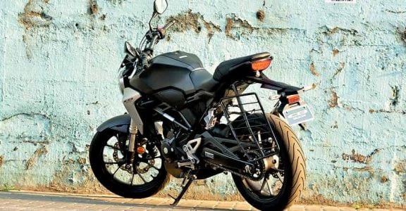 CB300R is Honda's international offering in the entry-level naked sports category. A sports bike much-awaited by enthusiasts in India. Why? There is only one answer, quality. You could blindly trust the build quality, says an admirer. Moreover, enthusiasts are expecting the same quality levels seen in international model here too. Is it true? Is it only about quality? What about performance? Well, here is our test ride report: Global star The CB300R was first launched in 2017. It then came as a replacement for the CB300F model, which was a naked bike with sporty looks. However, CB300R is a mix of sportiness and retro style. Superb finish When we first saw CB300R at EVM Honda Wing World Cochin, we understood why there is so much talk about the quality aspect - the build quality is pretty impressive. The paint quality and finishing too are top class. Honda is calling it the Neo-Sports Cafe. It sports the chiselled looks of a street sports bike. The body panels are sleek. The round headlamp ooze quality and design excellence. The blacked-out engine and alloys stand out. The fuel tank is long and muscular. Knee recesses are deep and can comfortably accommodate your knees. The silver scoop next to it adds to its looks. The CB300R shares its design elements with its bigger brother CB100R. Engine and other components are in black theme. There are some silver finishes at some places, which add to its premium feel. The LCD instrument console is fully digital that is clearly visible in bright daylight too. It shows gear shift indicators, average mileage and instant fuel efficiency etc. It features a flat handle bar that supports an aggressive riding position. The quality of switches is top notch. The position of horn switch could create some confusion initially. The bike is built around a diamond type trellis frame. It is designed in such a way that the rider’s weight is brought closer to the centre of the motorcycle. The CB300R weighs only 147 kg thus making it a pretty nimble handling bike. Compared to its rivals like KTM Duke 390, BMW 310R, it weighs considerably less. The wheelbase is also shorter than the rivals at 1344 mm. The split seat offers good cushioning. You sit 800 mm off the ground (Duke 390 - 830mm, G310 - 785 mm) which makes it easy for short riders. The tail section gets a sporty design. The dual chamber exhaust on the rear sports contrasting black with chrome underslung. Engine The CB300R is powered by a 286.01 cc liquid-cooled single-cylinder engine. It churns out 30.4 bhp of peak power and 27.4 Nm of peak torque. The engine comes mated to a six-speed manual transmission. The engine is very refined and delivers what is generally expected from a Honda. Throttle response is excellent. Though it has good low-end grunt, the mid-range is commendable. The power delivery is smooth. Ride comfort is another standout feature of the CB300R. Handling is sharp and you can filter through city traffic easily. Straight-line stability is good even at higher speeds. Even if you are riding for the first time, the CB300R offers you the same feel of a bike that you have been using for long. The bike gets fat 41 mm USD forks up front and a seven-step pre-load adjustable monoshock at the rear. It also gets a dual-channel ABS (anti-lock braking system) with an inertia measuring unit which distributes braking of the ABS. The motorcycle features disc brakes both up front and at the back with a radially-mounted, four-piston caliper taking care of braking duties up front and a single-piston caliper unit at the rear. The last word The CB300R boasts international build quality, classy looks and a sporty feel. The ride quality and performance too are superb. Vehicle provided by ECM Honda Wing World Cochin Ph. 9895661188 CB300R is Honda's international offering in the entry-level naked sports category. A sports bike much-awaited by enthusiasts in India. Why? There is only one answer, quality. You could blindly trust the build quality, says an admirer. Moreover, enthusiasts are expecting the same quality levels seen in international model here too. Is it true? Is it only about quality? What about performance? Well, here is our test ride report: Global star The CB300R was first launched in 2017. It then came as a replacement for the CB300F model, which was a naked bike with sporty looks. However, CB300R is a mix of sportiness and retro style. Superb finish When we first saw CB300R at EVM Honda Wing World Cochin, we understood why there is so much talk about the quality aspect - the build quality is pretty impressive. The paint quality and finishing too are top class. Honda is calling it the Neo-Sports Cafe. It sports the chiselled looks of a street sports bike. The body panels are sleek. The round headlamp ooze quality and design excellence. The blacked-out engine and alloys stand out. The fuel tank is long and muscular. Knee recesses are deep and can comfortably accommodate your knees. The silver scoop next to it adds to its looks. The CB300R shares its design elements with its bigger brother CB100R. Engine and other components are in black theme. There are some silver finishes at some places, which add to its premium feel. The LCD instrument console is fully digital that is clearly visible in bright daylight too. It shows gear shift indicators, average mileage and instant fuel efficiency etc. It features a flat handle bar that supports an aggressive riding position. The quality of switches is top notch. The position of horn switch could create some confusion initially. The bike is built around a diamond type trellis frame. It is designed in such a way that the rider’s weight is brought closer to the centre of the motorcycle. The CB300R weighs only 147 kg thus making it a pretty nimble handling bike. Compared to its rivals like KTM Duke 390, BMW 310R, it weighs considerably less. The wheelbase is also shorter than the rivals at 1344 mm. The split seat offers good cushioning. You sit 800 mm off the ground (Duke 390 - 830mm, G310 - 785 mm) which makes it easy for short riders. The tail section gets a sporty design. The dual chamber exhaust on the rear sports contrasting black with chrome underslung. Engine The CB300R is powered by a 286.01 cc liquid-cooled single-cylinder engine. It churns out 30.4 bhp of peak power and 27.4 Nm of peak torque. The engine comes mated to a six-speed manual transmission. The engine is very refined and delivers what is generally expected from a Honda. Throttle response is excellent. Though it has good low-end grunt, the mid-range is commendable. The power delivery is smooth. Ride comfort is another standout feature of the CB300R. Handling is sharp and you can filter through city traffic easily. Straight-line stability is good even at higher speeds. Even if you are riding for the first time, the CB300R offers you the same feel of a bike that you have been using for long. The bike gets fat 41 mm USD forks up front and a seven-step pre-load adjustable monoshock at the rear. It also gets a dual-channel ABS (anti-lock braking system) with an inertia measuring unit which distributes braking of the ABS. The motorcycle features disc brakes both up front and at the back with a radially-mounted, four-piston caliper taking care of braking duties up front and a single-piston caliper unit at the rear. The last word The CB300R boasts international build quality, classy looks and a sporty feel. The ride quality and performance too are superb. Vehicle provided by ECM Honda Wing World Cochin Ph. 9895661188