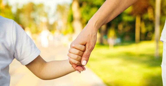 parents Cropped close up of a boy and grandmother holding hands. CLose up of hands of a child and parent on the walk at the local park in summer family love bonding children parenting family weekend leisure