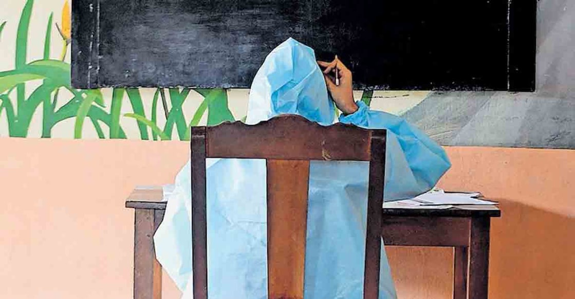 covid-exam COVID-19 positive student at Manjeri NSS Higher Secondary School writing SSLC exam wearing a PPE kit. Photo: Fahad Muneer, Manorama