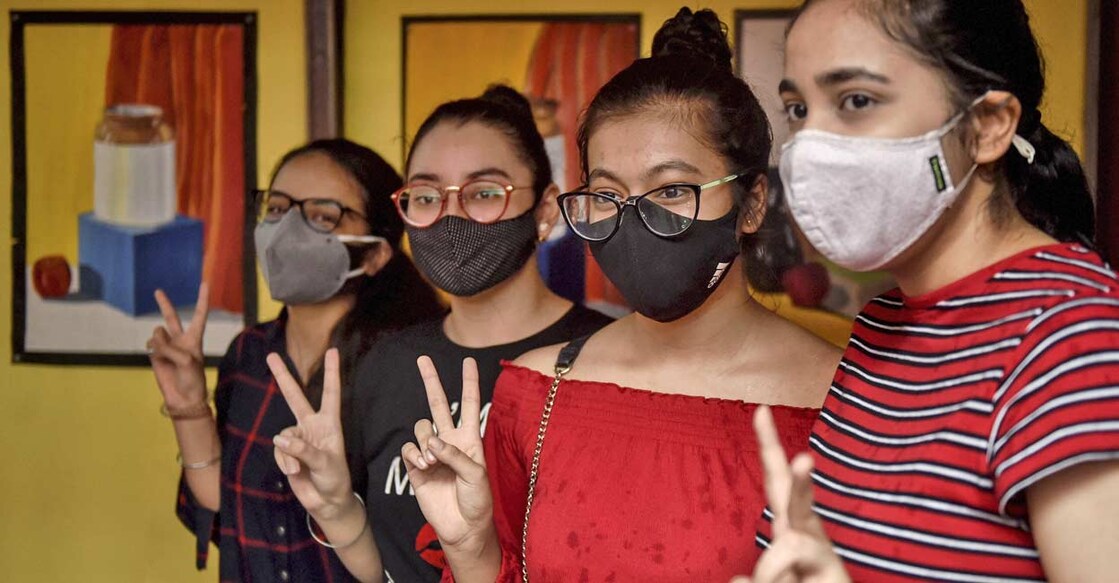 Students celebrate their success after the announcement of CBSE's class 12th results, at their school in New Delhi. PTI