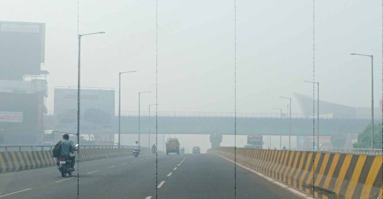 The Vyttila flyover seen through the smoke from the Brahmapuram waste dump yard. Photo: Manorama