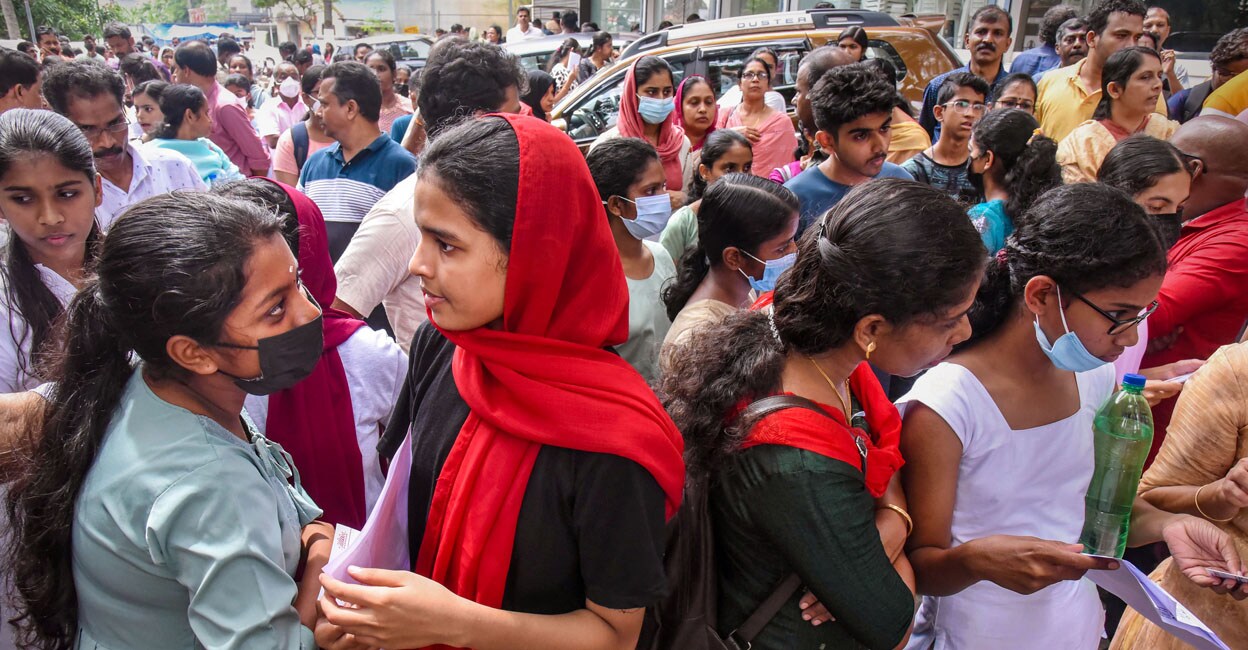 Applicants waiting outside an examination centre to appear in the NEET-UG exam in Kochi on Sunday. Photo: PTI/ A S Satheesh
