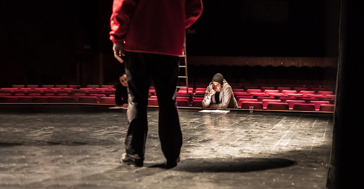 961551098 Rehearsal in theatre with actors on stage. Photo: iStock/CasarsaGuru