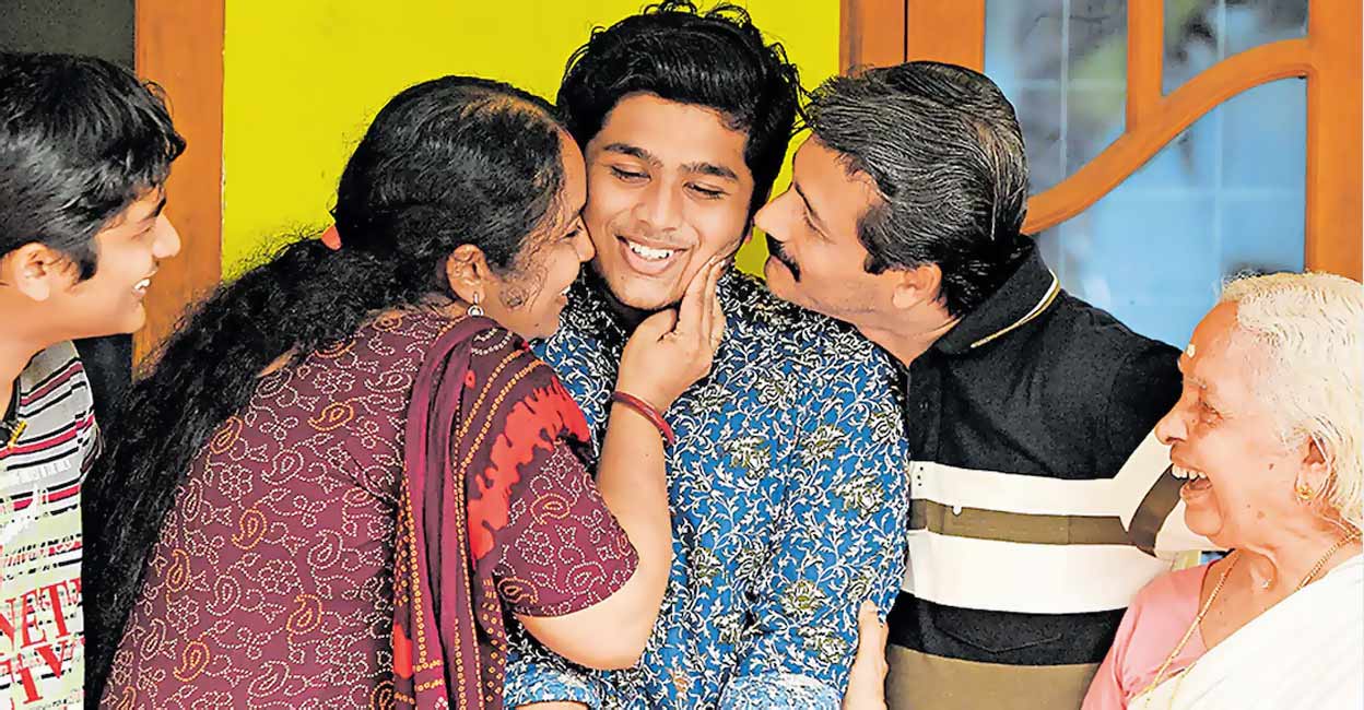 P Devanand from Madaram in Chandanakkavu, Alappuzha, who secured the first rank in the state, celebrating with his family. Photo: Manorama

