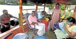 Kuttanad bank hires boat for customers after office premises were flooded Kuttanad bank hires boat for customers after office premises were flooded