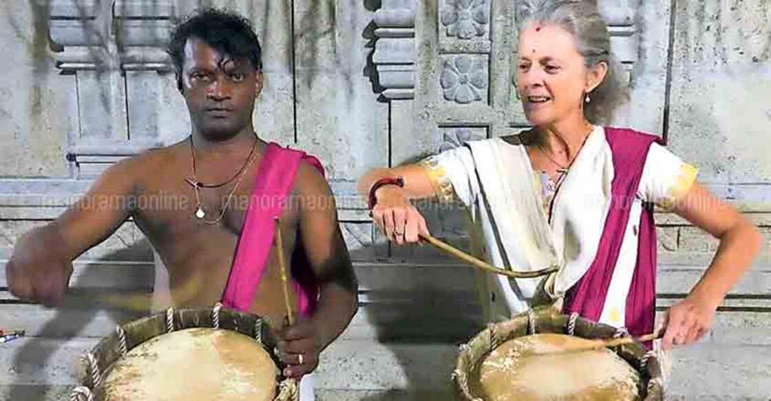 English woman plays chenda at Kovalam temple festival