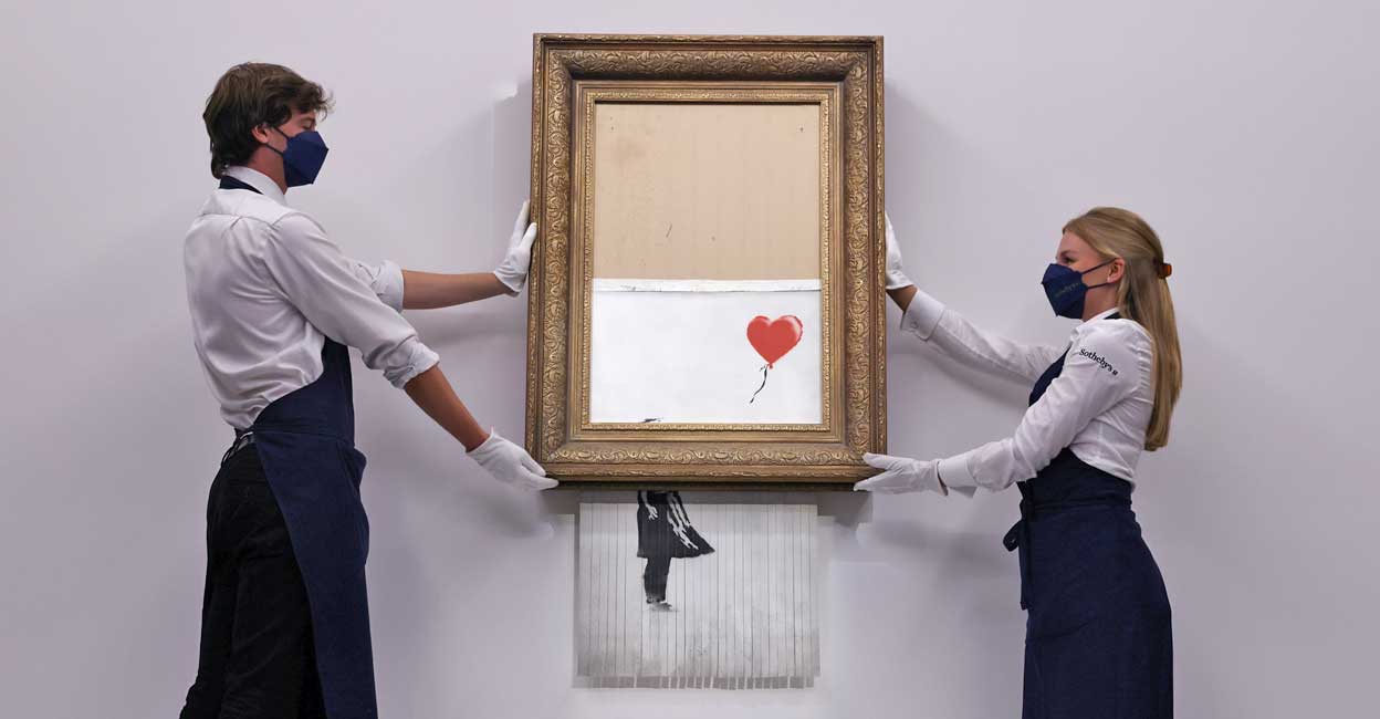 Half-shredded Banksy fetches $25.4 million on return to Sotheby's Half-shredded Banksy fetches $25.4 million on return to Sotheby's