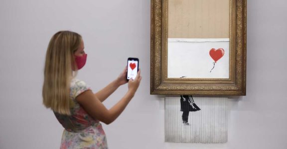 Half-shredded Banksy fetches $25.4 million on return to Sotheby's Half-shredded Banksy fetches $25.4 million on return to Sotheby's