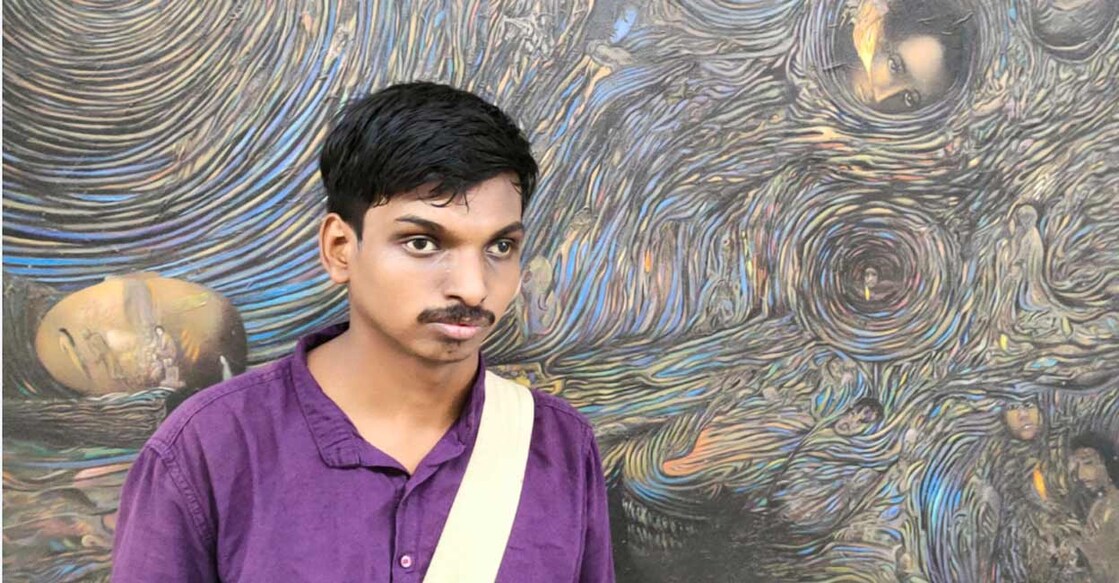 Nadeer poses in front of a painting by him. Photo: Special arrangement