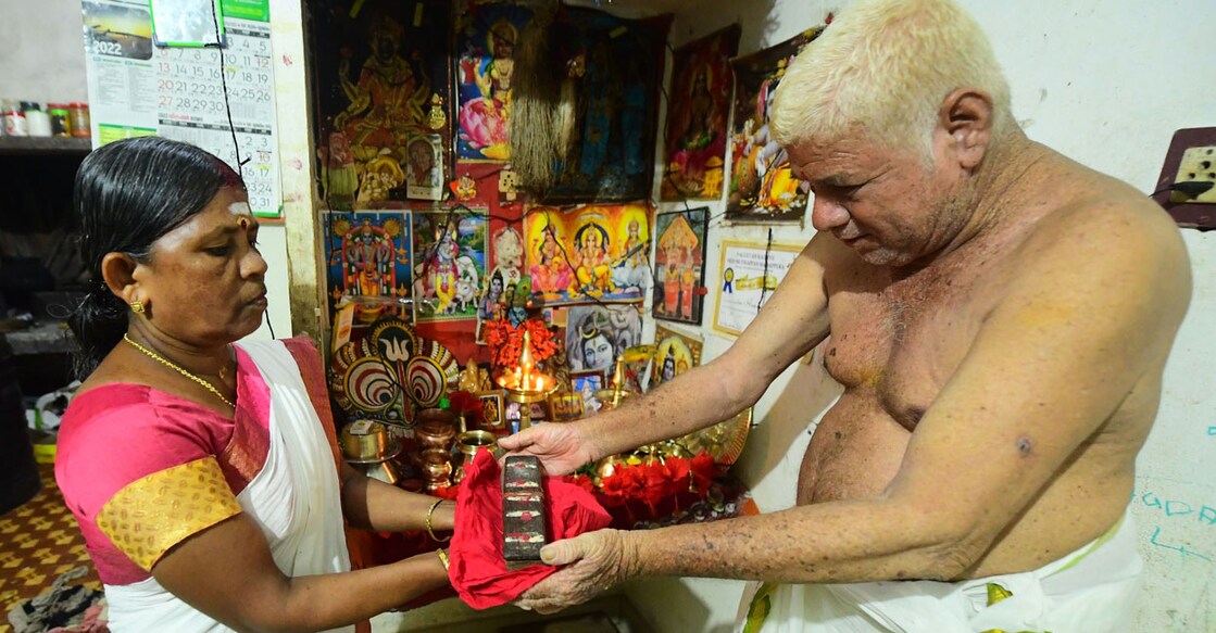 Ambujakshi receiving the sacred Pallimaala text from Kannan Panicker of Kaattuparambu Tharavadu. Photo: Dhanesh Ashokan