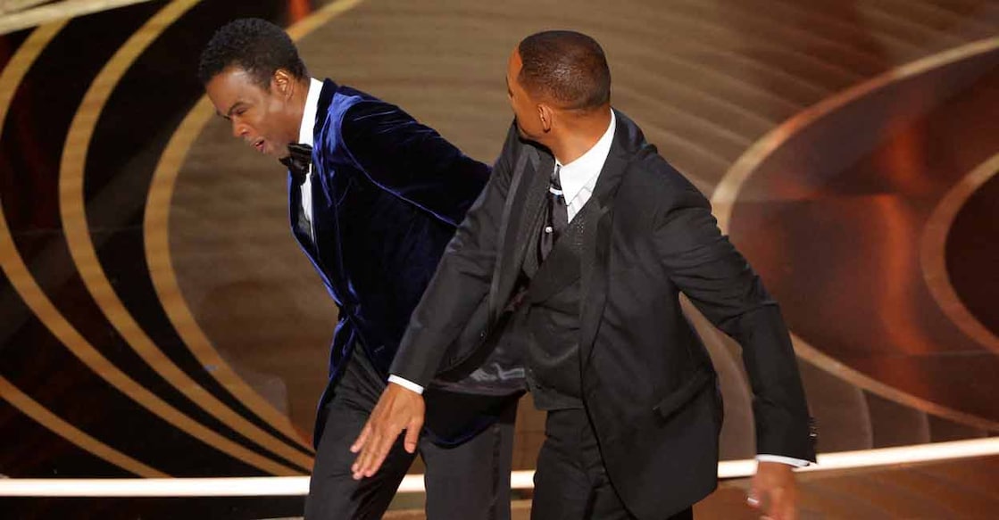 FILE PHOTO: Will Smith (R) hits Chris Rock as Rock spoke on stage during the 94th Academy Awards in Hollywood, Los Angeles, California, U.S., March 27, 2022. REUTERS/Brian Snyder
