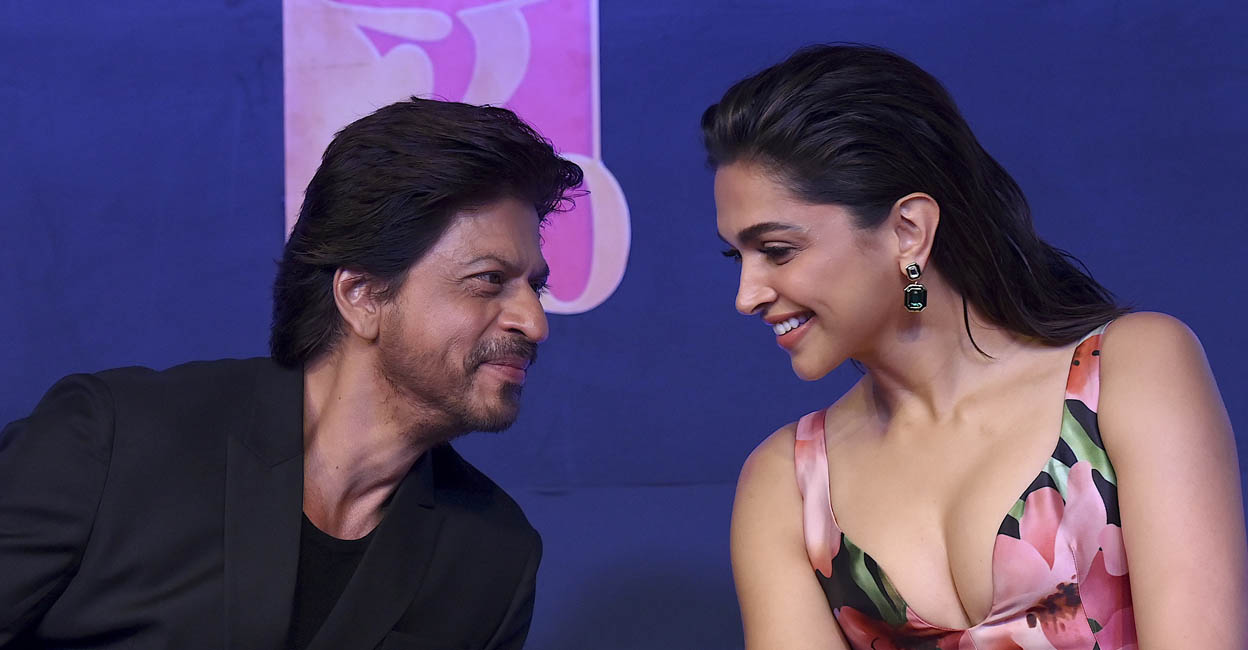 Bollywood actors Deepika Padukone (R) and Shah Rukh Khan (L) gesture during a media event of their Hindi-language film ‘Pathaan’ in Mumbai on January 30, 2023. - Superstar Shah Rukh Khan thanked fans Monday after his new film "Pathaan" smashed Indian box office records following its release last week, bringing hope to Bollywood after a spate of weak showings. (Photo by SUJIT JAISWAL / AFP)