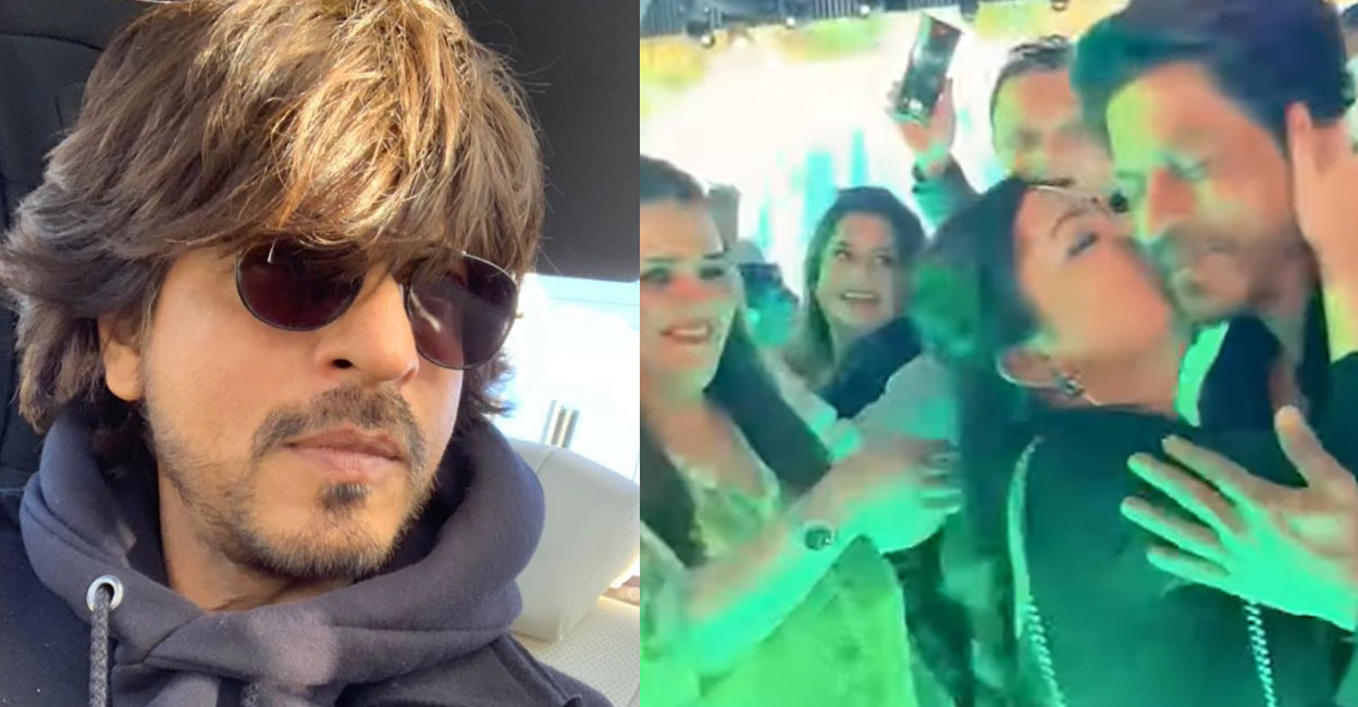 Khan is seen walking on the stage with his bodyguards when a young woman unexpectedly walks to him and plants a kiss on his cheek. Video still: YouTube shorts