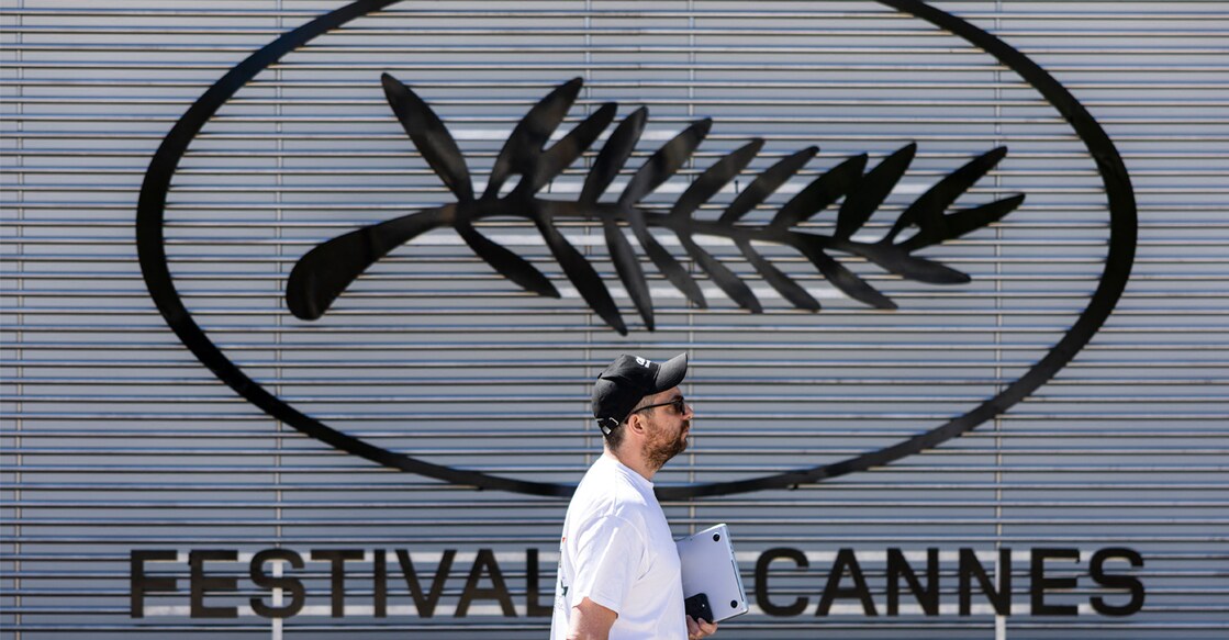 A pedestrian walks past the logo of the Cannes Film Festival on the eve of the 78th edition of the Cannes Film Festival. Photo: Sameer Al-Doumy/ AFP