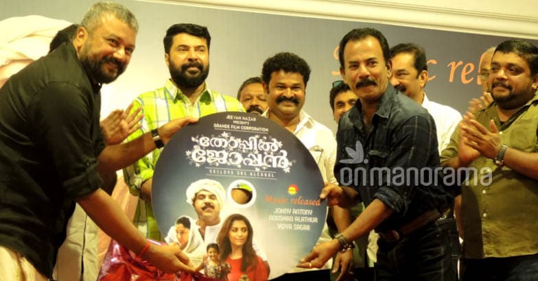 Thoppil Joppan audio launch Actor Jayaram (left) hands over a large replica of an audio CD of 'Thoppil Joppan' to Major Ravi as the movie's lead actor Mammootty (center), director Johny Antony and others look on. Photo: Anand Menon P