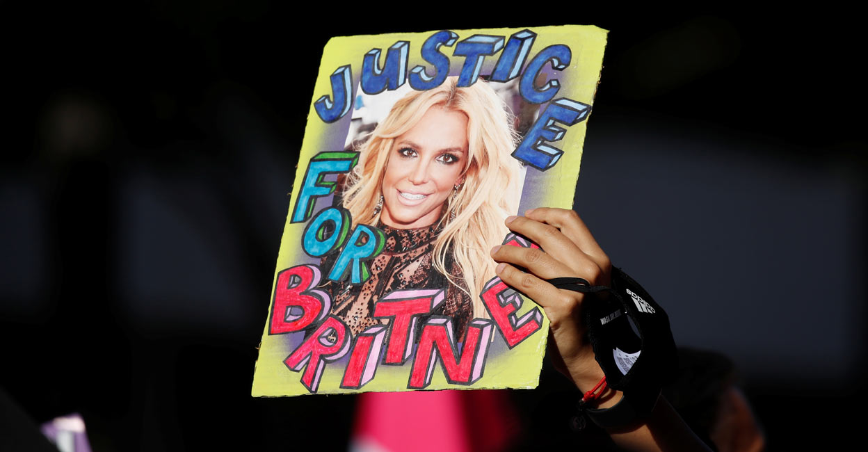 A supporter of singer Britney Spears holds up a picture of the pop star with the words "Justice for Britney" during celebrations for the termination of her conservatorship. REUTERS/Mike Blake