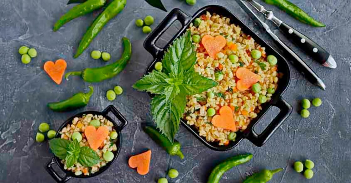 Pilav from bulgur with vegetables, carrots, green peas and fresh mint. Healthy food, vegetarian recipes