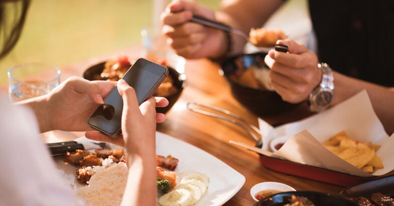 Using phone while eating Using phone while eating