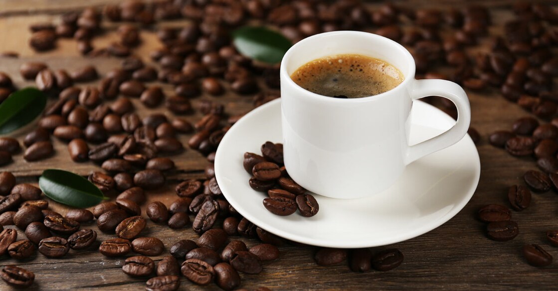 Black coffee next to coffee beans. Photo: Shutterstock/Africa Studio