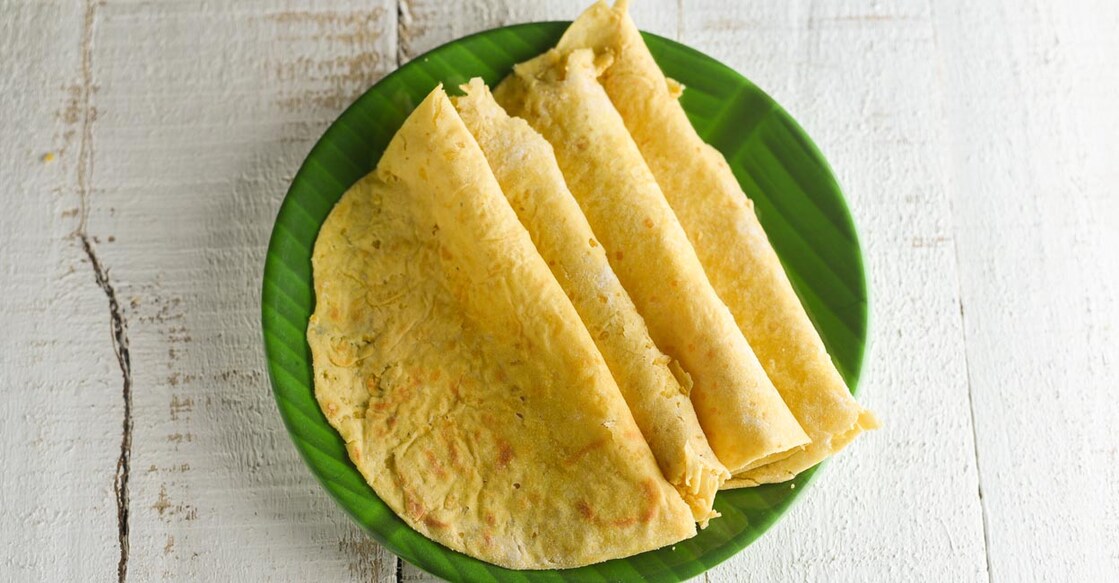 Boli Trivandrum special sweet food on banana leaf plate on white background. Kerala tea time food. Top view of South Indian snacks  delicacy.