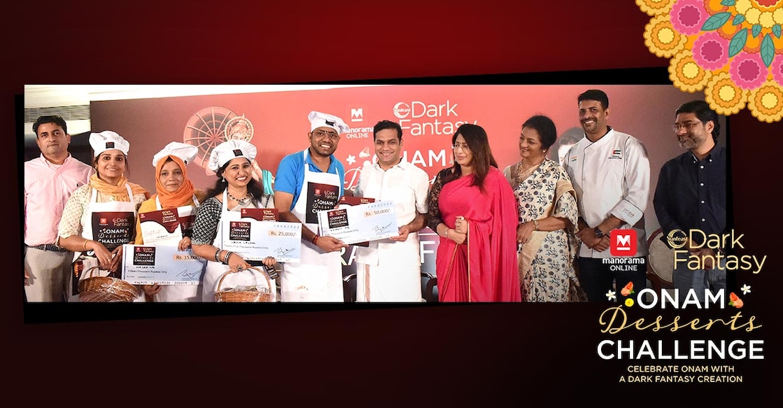 Rajeesh P R from Kottayam receiving the first prize of the Manorama Online Dark Fantasy Dessert Challenge contest held in Kochi, from Hibi Eden MP. Also seen are second prize winner Leena Lalson from Bengaluru; third prize winner Haseena from Kozhikode; Aneesha Mahroof, also from Kozhikode, who was selected for a special mention prize by the jury; Malayala Manorama Online Marketing Senior General Manager Bobby Paul; judges Dr Lakshmi Nair, Anita Isaac and Dhe Puttu corporate chef Sinoy John and ITC branch manager Bijith.