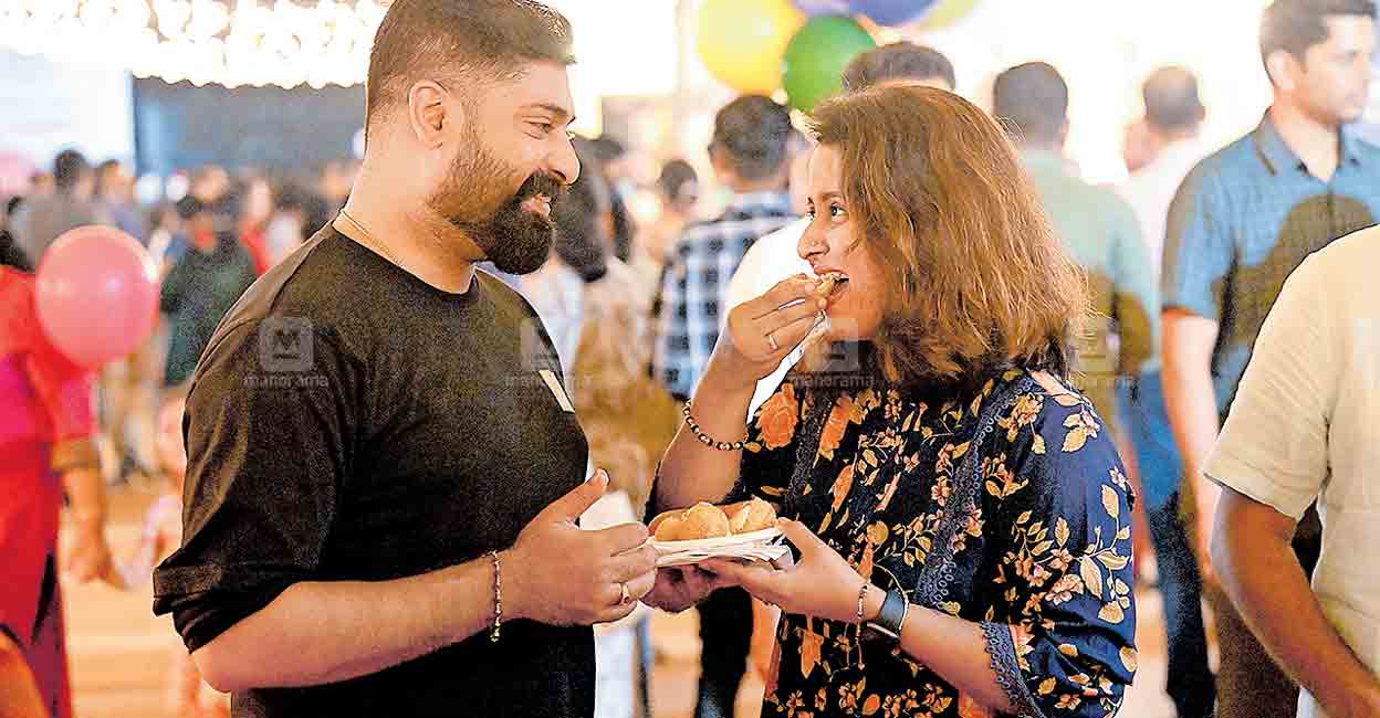 Visitors enjoying a snack at the food fest ground. Photo: Manorama