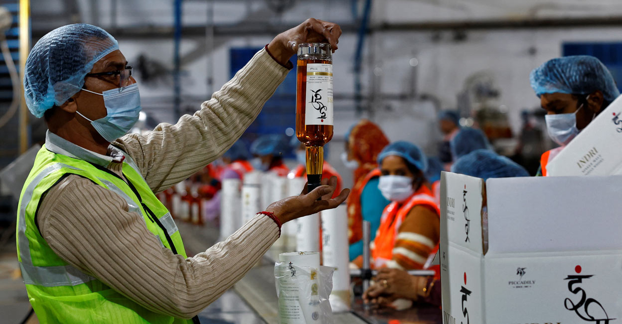 A worker inspects a whisky bottle before packaging inside Piccadily Distilleries, in Indri, in the northern state of Haryana, India, December 14, 2023. Photo: Reuters/Sahiba Chawdhary
