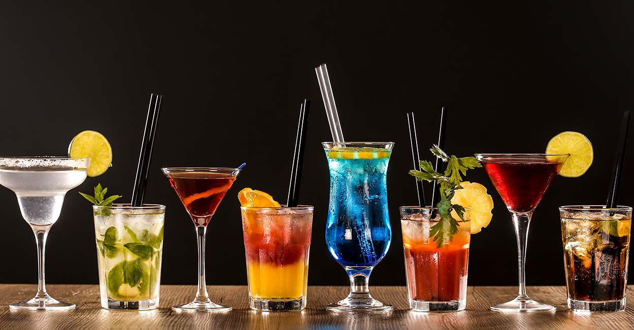 Colorful cocktails on bar counter - Margarita, Mojito, Blue Lagoon, Bloody Mary, Tequila Sunrise, Rob Roy and Cuba Libre. Photo: iStock/GoodLifeStudio