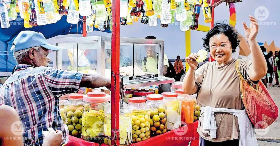 South Korean culinary expert Hong Chu Park is giving the famous pickled pineapple of Kozhikode beach a go. Chef Hong Chu is in Kozhikode to take part in Manorama Hortus where she is hosting a Korean cooking classes and a Kimchi workshop. Photo: Manorama
