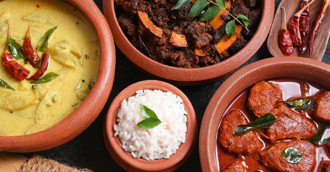 Traditional Kerala rice with yellow mango curry, fish curry, and beef roast. Photo: Shutterstock/Santhosh Varghese