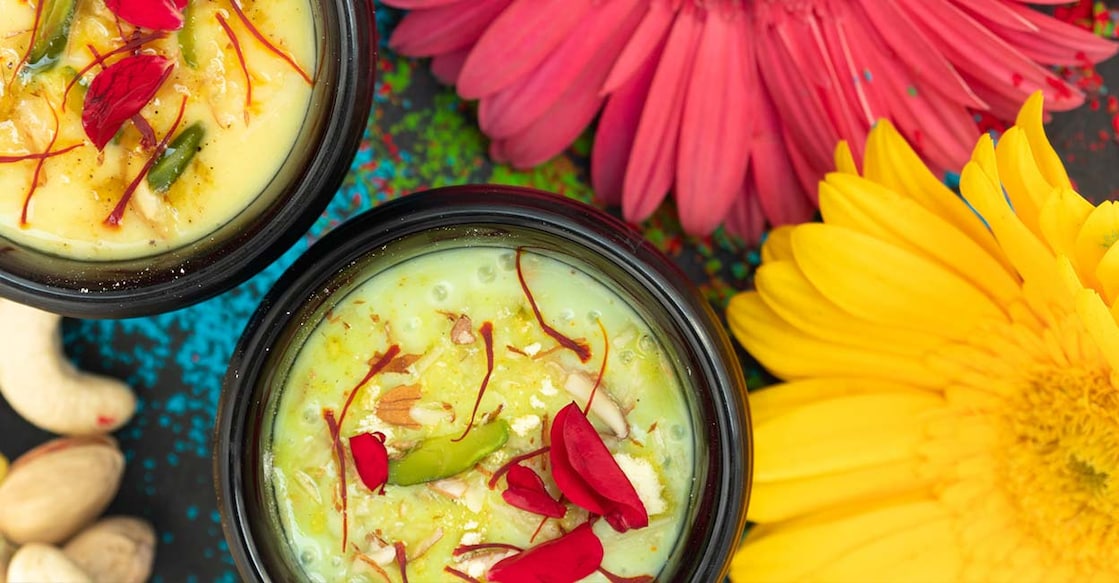 Kesar badam thandai Holi special Indian beverage kesar badam thandai garnished with rose petals. Photo: iStock/Rangeecha
