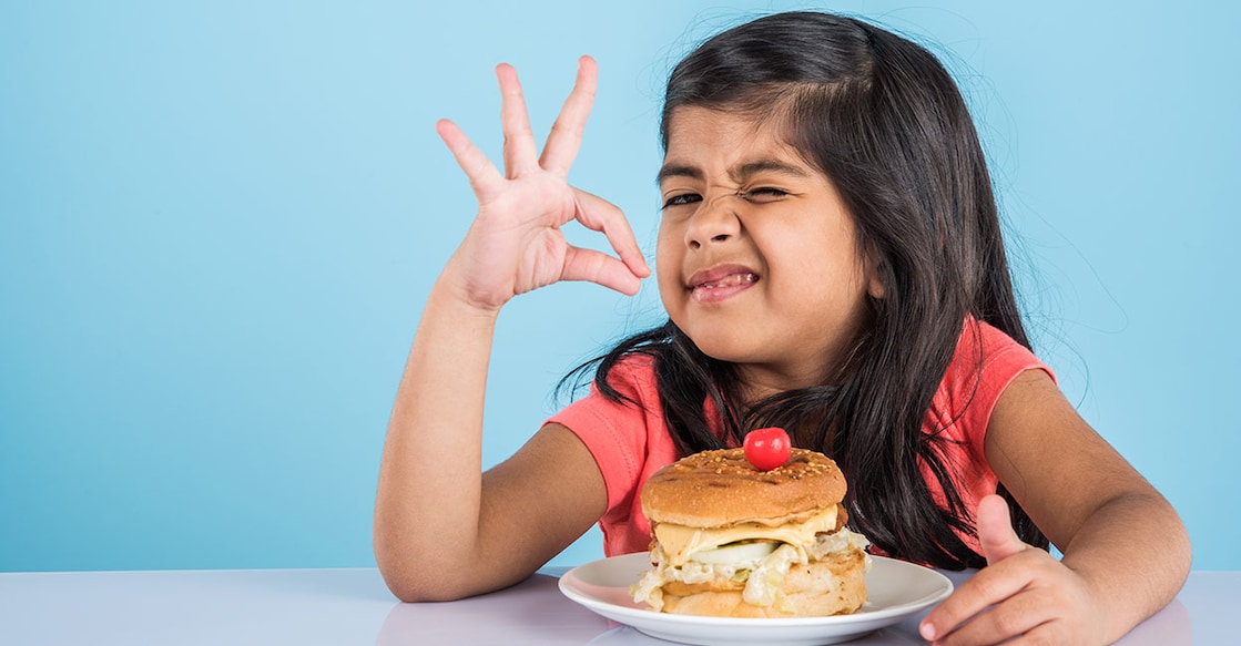 Girl eating burger Representative image: Shutterstock/StockImageFactory.com