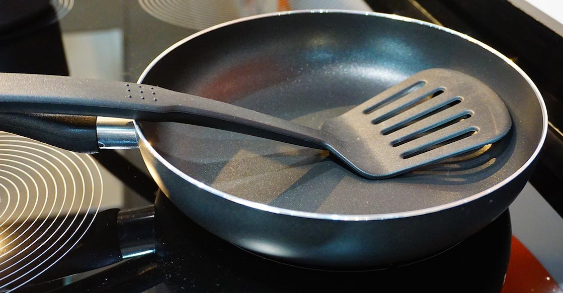 Non-stick pan Metal black frying pan with a non-stick coating on electric stove. Photo: iStock/Supersmario