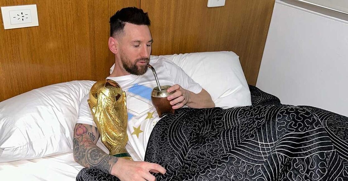 Argentina's captain and forward Lionel Messi sips mate in bed while holding the FIFA World Cup Trophy at the Argentine Football Association (AFA) training centre in Ezeiza, Buenos Aires province, Argentina, on December 20, 2022. Photo: Instagram @leomessi