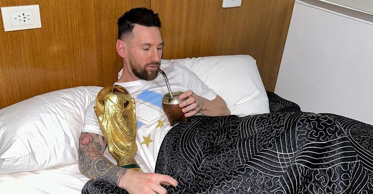 Argentina's captain and forward Lionel Messi sips mate in bed while holding the FIFA World Cup Trophy at the Argentine Football Association (AFA) training centre in Ezeiza, Buenos Aires province, Argentina, on December 20, 2022. Photo: Instagram @leomessi