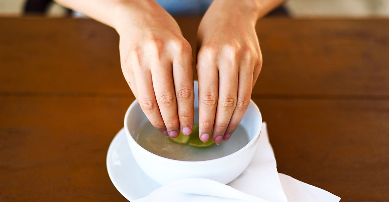 Lime finger bowl Woman washing hands in lime water in a restaurant. Photo: iStock/Creative-Family