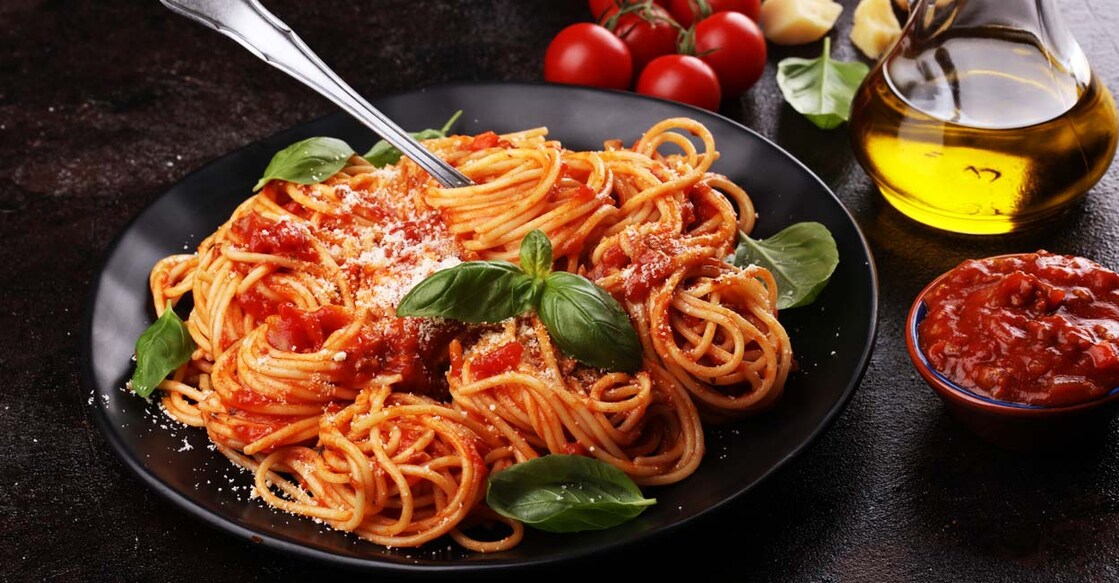 1175766662 Plate of delicious spaghetti Bolognaise or Bolognese with savory minced beef and tomato sauce garnished with parmesan cheese