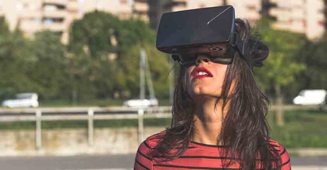 Beautiful young woman wearing virtual reality headset