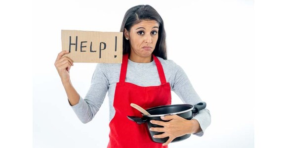 cook Portrait of desperate helpless inexperienced home cook woman asking for help wearing red apron learning to cook in cooking classes isolated on white background.