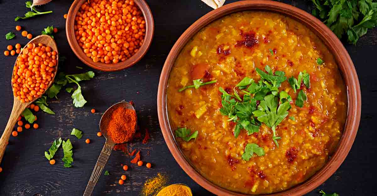 1130228940 Indian dal. Food. Traditional Indian soup lentils. Indian Dhal spicy curry in bowl, spices, herbs, rustic black wooden background. Top view. Authentic Indian dish. Overhead. Flat lay